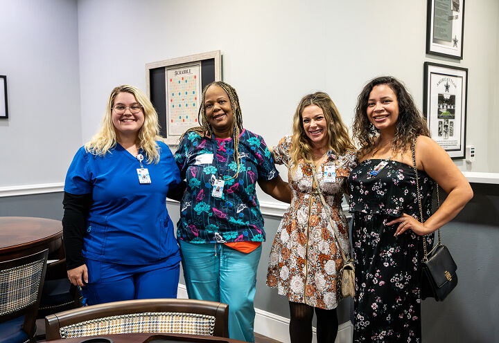 Female Nurses Smiling Inside a Memory Care Facility Female Nurses Smiling Inside a Memory Care Facility
