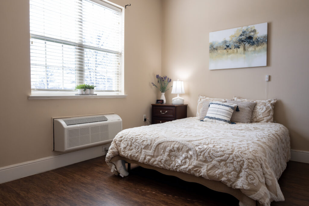 Private Resident Bedroom with Bright Window at Memory Care Facility