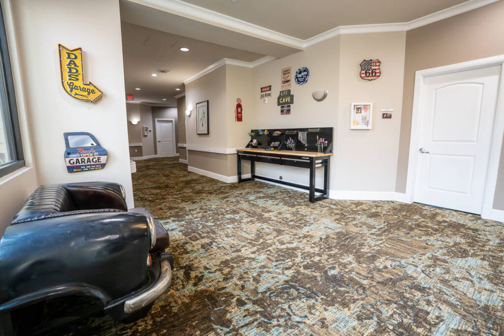 Garage Themed Lounge with Vintage Signs at Memory Care Community