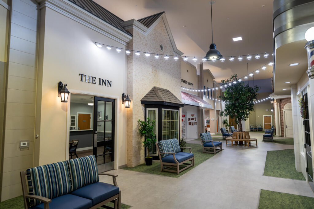 Indoor Town Square with Inn Entrance at Memory Care Community
