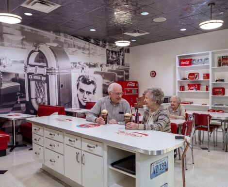 Elderly Couple Enjoying Ice Cream at Memory Care Homes Diner Elderly Couple Enjoying Ice Cream at Memory Care Homes Diner